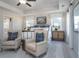 Inviting main bedroom with tray ceiling, neutral tones, cozy sitting area, and ample natural light at 4035 Bucolic Loop, Myrtle Beach, SC 29588