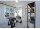 Well-lit office space with large windows, dark wood desk, and stylish decor at 4035 Bucolic Loop, Myrtle Beach, SC 29588