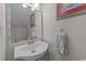 Cozy bathroom with a single sink vanity, framed mirror, and beach-themed artwork at 404 71St Ave. N # 709, Myrtle Beach, SC 29572