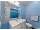 Light blue bathroom featuring a white vanity and sink with a blue shower curtain at 404 71St Ave. N # 709, Myrtle Beach, SC 29572