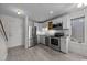 Well-lit kitchen boasting stainless steel appliances, white cabinets, and wood-look flooring at 404 71St Ave. N # 709, Myrtle Beach, SC 29572