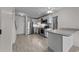 Open-concept kitchen featuring stainless appliances, a breakfast bar, and wood-look flooring at 404 71St Ave. N # 709, Myrtle Beach, SC 29572