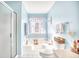 Bright bathroom with soaking tub, shower, and soft blue walls at 4283 Santolina Way # H, Murrells Inlet, SC 29576