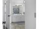 Bright bathroom with a white vanity, mirror, and tiled floors, perfect for refreshing mornings at 4291 Parkway Ln. # 4291, Little River, SC 29566