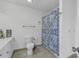 Functional bathroom with a tiled floor, toilet, and a shower with a blue patterned curtain at 4291 Parkway Ln. # 4291, Little River, SC 29566