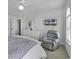 Bright bedroom features neutral colors, ceiling fan, television, and comfortable recliner at 4291 Parkway Ln. # 4291, Little River, SC 29566