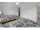 Bright bedroom featuring two twin beds with colorful paisley patterns, a closet, and neutral carpeting at 4291 Parkway Ln. # 4291, Little River, SC 29566