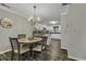 Dining area with a chandelier and views to a modern white kitchen with breakfast bar seating at 4291 Parkway Ln. # 4291, Little River, SC 29566