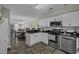 Bright kitchen with white cabinets, stainless steel appliances, and black countertops, flowing into the living area at 4291 Parkway Ln. # 4291, Little River, SC 29566