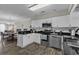 Bright kitchen with white cabinets, stainless steel appliances, and black countertops, open to the dining area at 4291 Parkway Ln. # 4291, Little River, SC 29566