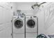 Efficient laundry room with a stacked washer and dryer set and functional shelving at 4291 Parkway Ln. # 4291, Little River, SC 29566