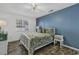 Comfortable bedroom with a queen bed, blue accent wall, and ample natural light for a relaxing retreat at 4291 Parkway Ln. # 4291, Little River, SC 29566