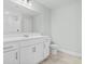 Bathroom featuring white vanity, toilet, tile flooring, and large mirror at 4344 Jones Rd., Myrtle Beach, SC 29588