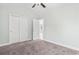 Bright bedroom features neutral walls, plush carpet, ceiling fan and closet at 4344 Jones Rd., Myrtle Beach, SC 29588