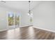 Open dining room features a modern chandelier, sliding glass door to patio, and backyard views at 4344 Jones Rd., Myrtle Beach, SC 29588