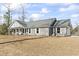 Charming single story home with gray siding, white trim, and a well-manicured front yard at 4344 Jones Rd., Myrtle Beach, SC 29588