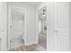 Hallway shot with bathroom and bedroom views featuring wood-look and gray tile at 4344 Jones Rd., Myrtle Beach, SC 29588