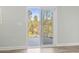 Sliding glass doors reveal a serene view of the lush backyard and patio at 4344 Jones Rd., Myrtle Beach, SC 29588