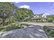 Spacious clubhouse with inviting porch, framed by mature trees and manicured landscaping at 4413 Eastport Blvd. # F-1, Little River, SC 29566