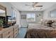 Bright main bedroom with a ceiling fan and ample natural light from the shuttered windows at 4413 Eastport Blvd. # F-1, Little River, SC 29566