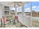 Relaxing screened porch with water views, ceiling fan, and comfortable seating at 4413 Eastport Blvd. # F-1, Little River, SC 29566