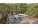 Aerial view of the community pool and surrounding clubhouse enveloped by trees, offering privacy at 4430 Eastport Blvd. # L5, Little River, SC 29566