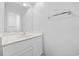 Bathroom vanity with white cabinetry, a mirror, and a chrome towel rack at 4430 Eastport Blvd. # L5, Little River, SC 29566