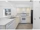Bright kitchen features tile backsplash, white appliances, and plenty of counter space at 4430 Eastport Blvd. # L5, Little River, SC 29566