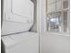 Efficient laundry area features a stacked washer and dryer near a bright window at 4430 Eastport Blvd. # L5, Little River, SC 29566