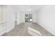 Bright living room with light gray flooring, ceiling fan, and sliding glass door to the outside at 4430 Eastport Blvd. # L5, Little River, SC 29566