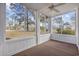 Relaxing screened porch with ceiling fan and views of the lush, green backyard at 4430 Eastport Blvd. # L5, Little River, SC 29566