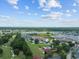A scenic aerial view overlooking a golf course, swimming pool, waterways, and condominiums in the neighborhood at 4440 Nassau Ct. # 502, Little River, SC 29566