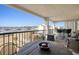 Balcony with dining table and seating overlooking the marina and waterway at 4440 Nassau Ct. # 502, Little River, SC 29566