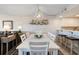 A white dining room set with chairs and table with view to the kitchen at 4440 Nassau Ct. # 502, Little River, SC 29566