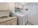 A functional laundry room featuring a washer, dryer, storage cabinets, and countertop at 4440 Nassau Ct. # 502, Little River, SC 29566