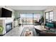 Comfortable living room featuring a fireplace and access to a scenic balcony with marina views at 4440 Nassau Ct. # 502, Little River, SC 29566