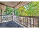 Covered balcony with a white railing overlooking a beautiful wooded area at 4466 Little River Inn Ln. # 906, Little River, SC 29566