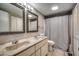 Bathroom with double vanity, framed mirrors, and walk-in shower with light at 4466 Little River Inn Ln. # 906, Little River, SC 29566