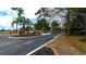 Entrance to community featuring mature landscaping and greenery at 4466 Little River Inn Ln. # 906, Little River, SC 29566