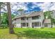 An exterior shot of a two-story townhome with double balconies overlooking a lush lawn at 4466 Little River Inn Ln. # 906, Little River, SC 29566