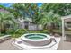 Community hot tub surrounded by trees and shrubbery with building in background at 4466 Little River Inn Ln. # 906, Little River, SC 29566