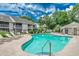 Community pool with lounge chairs, tables, and trees surrounding the property at 4466 Little River Inn Ln. # 906, Little River, SC 29566