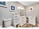 Bathroom featuring white vanity, framed artwork, and ample storage space at 451 Holly View Ln., Loris, SC 29569