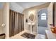 This bathroom features a pedestal sink, oval mirror and a shower with a brown shower curtain at 451 Holly View Ln., Loris, SC 29569