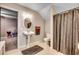 This is a bathroom with a pedestal sink, oval mirror, toilet, shower with brown curtain and neutral-colored walls at 451 Holly View Ln., Loris, SC 29569