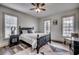 Bright bedroom with ample natural light from three windows, featuring a striking rug and dark furniture at 451 Holly View Ln., Loris, SC 29569