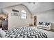 Cozy bedroom features an arched window, sitting area with loveseat, ceiling fan and patterned bedding at 451 Holly View Ln., Loris, SC 29569