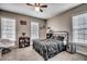 Cozy bedroom featuring neutral walls, plush carpet, ceiling fan and two windows for ample natural light at 451 Holly View Ln., Loris, SC 29569