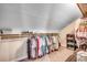 Walk-in closet with angled ceiling, with clothing hung on a long shelf and storage cube shelves at 451 Holly View Ln., Loris, SC 29569