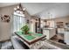 Inviting dining area with large window, modern light fixture, and open view into the bright, modern kitchen at 451 Holly View Ln., Loris, SC 29569